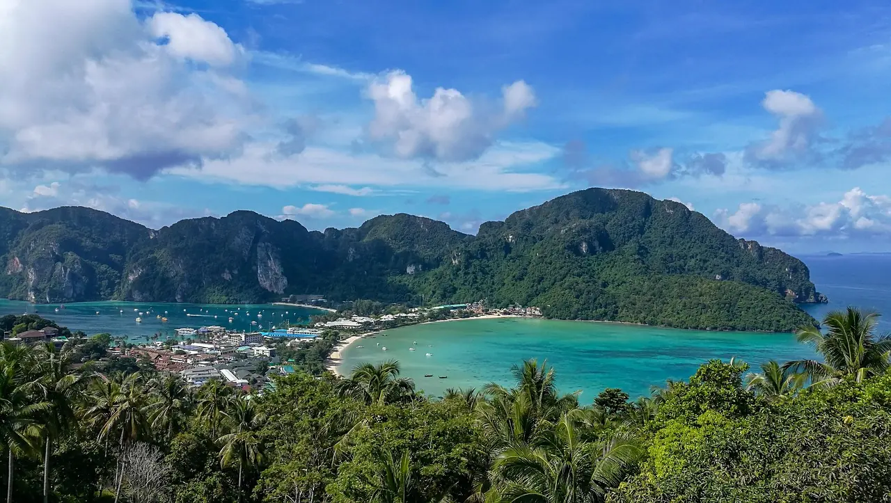 Twin bays joined by a sand isthmus seen from a limestone viewpoint