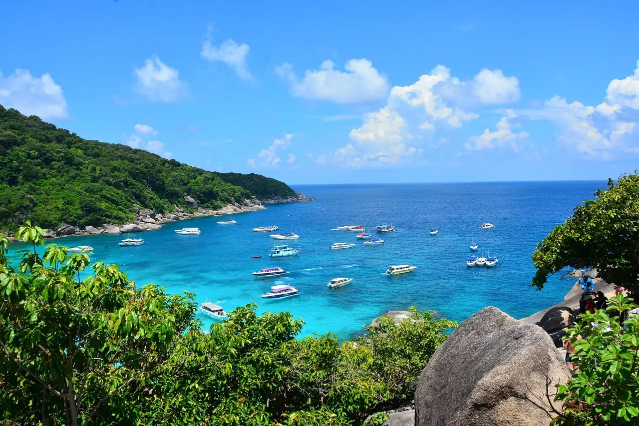 Granite boulders and white sand beach in clear water at the Similan Islands