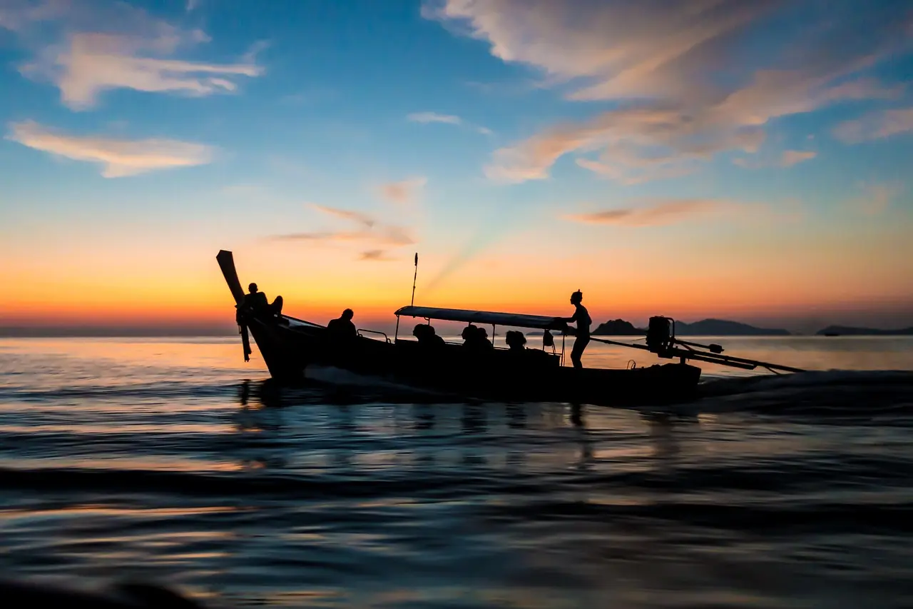 A charter yacht at anchor in the Andaman Sea at dusk