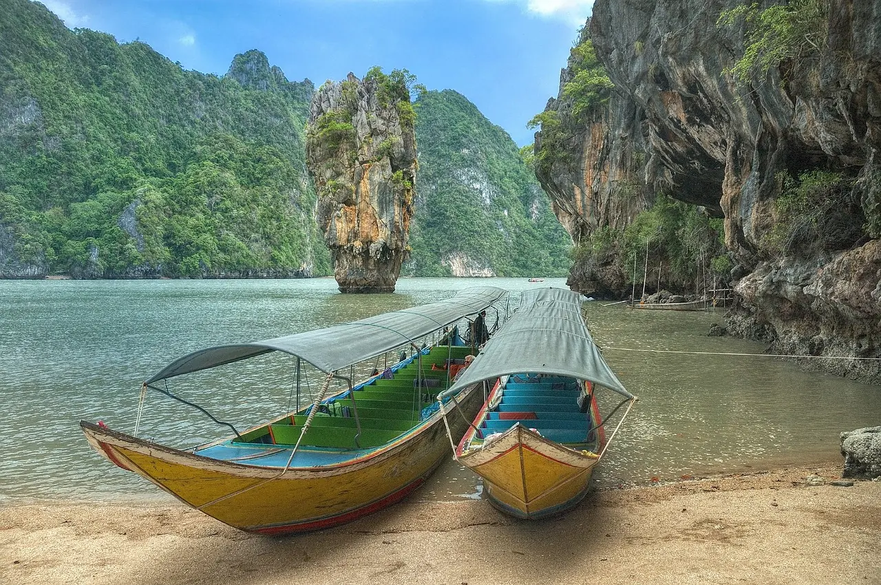 Catamaran anchored in a clear turquoise bay off a small island