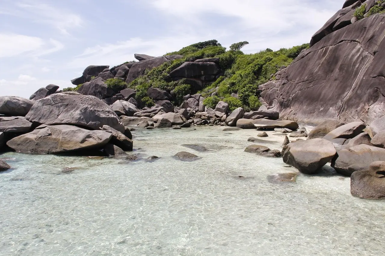 Granite boulders and white sand in very clear water at the Similan Islands
