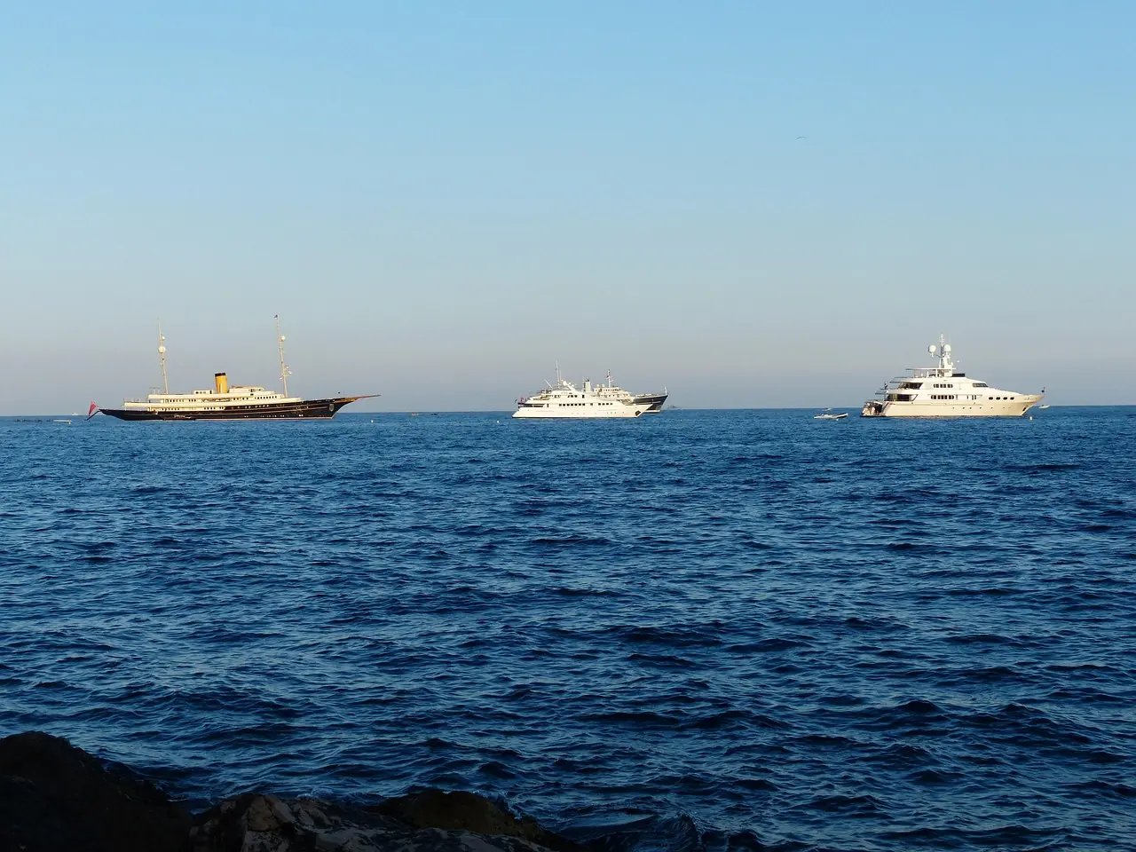 Planing motor yacht under way at speed in tropical water
