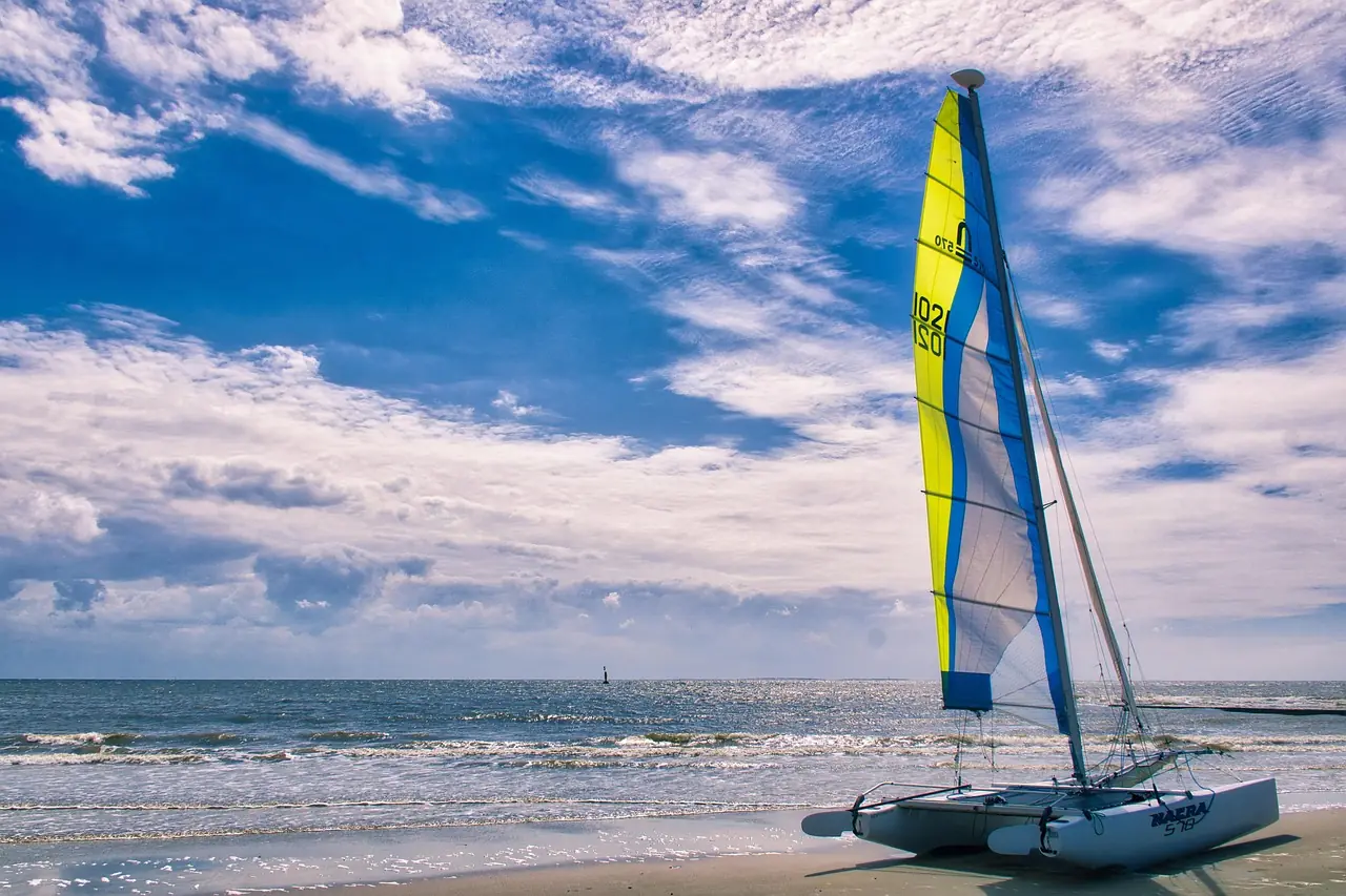Day charter catamaran with guests aboard in a clear bay