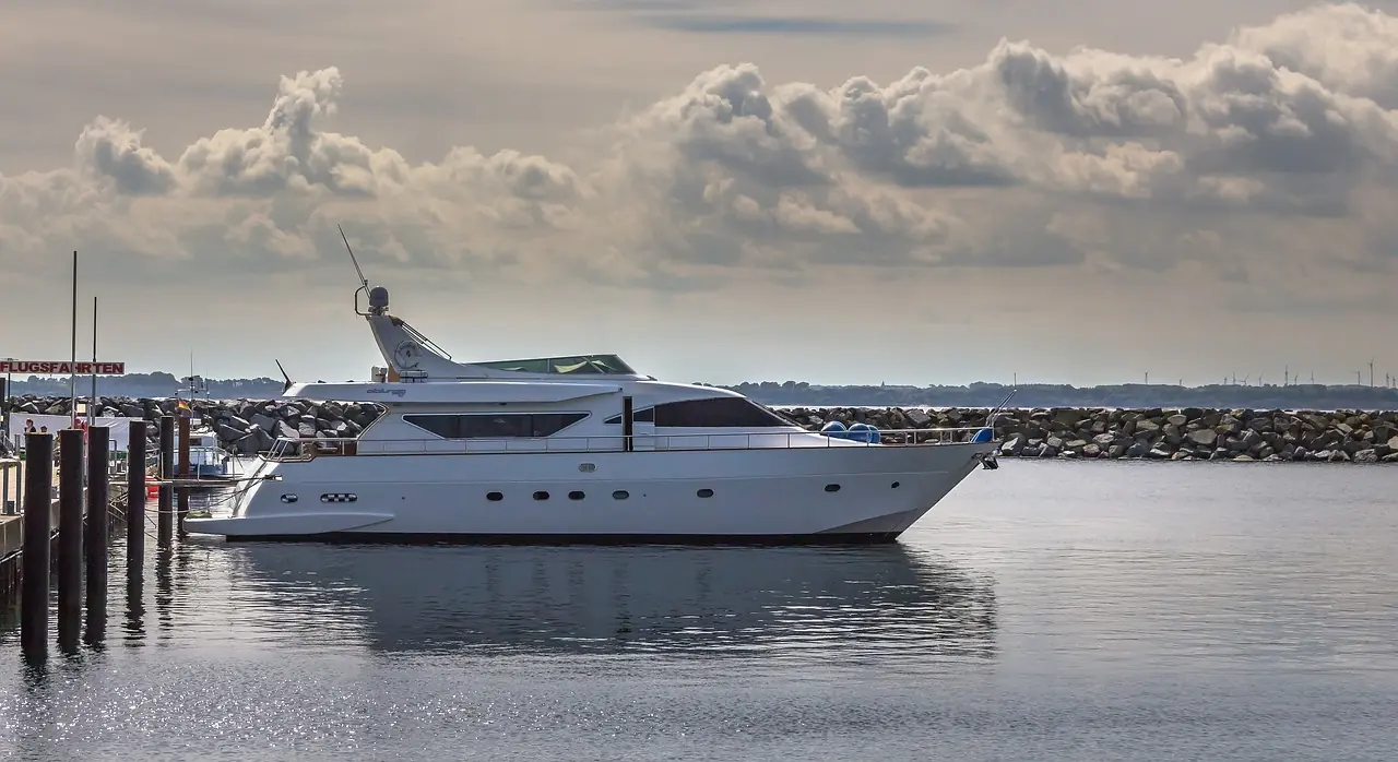 Flybridge motor yacht at anchor at dusk