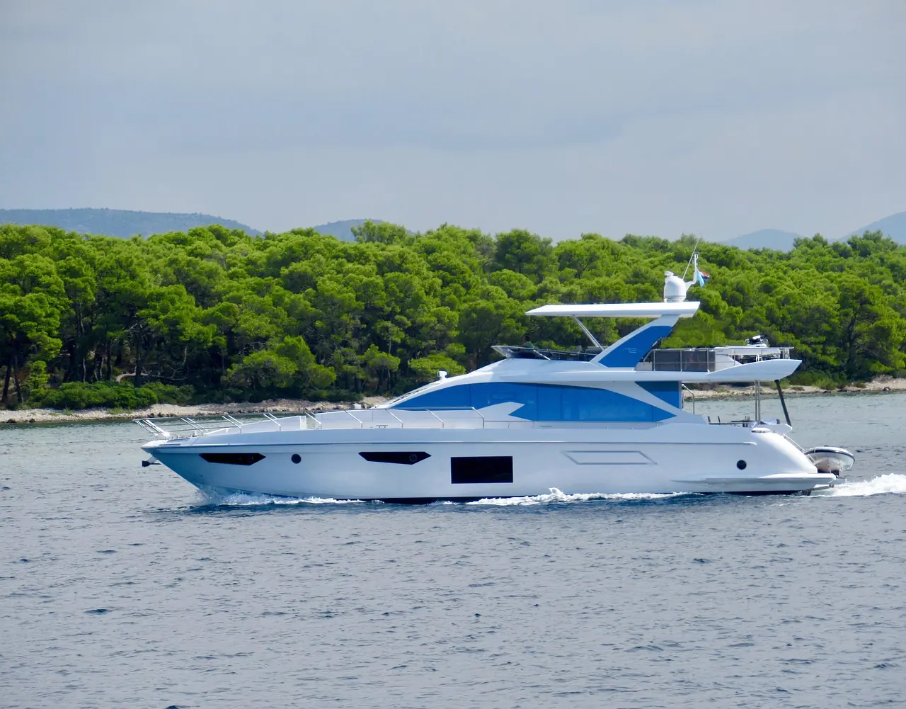 Italian motor yacht at anchor in clear water